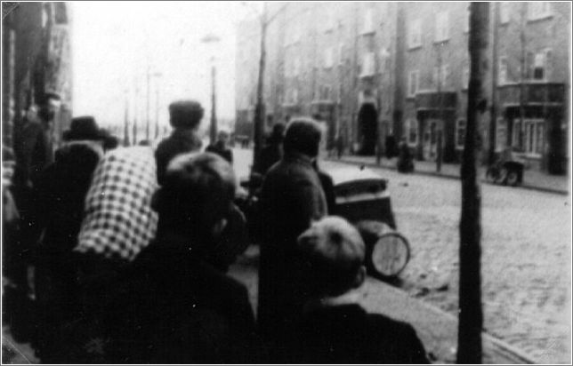 Dutch civilians in Amsterdam observing as Jews are rounded up.